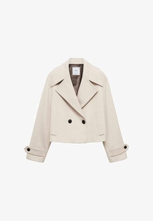 Beige cropped jakke lavet af uldblanding, har en dobbeltbrystet design, store revers og sorte knapper med foldede manchetter.