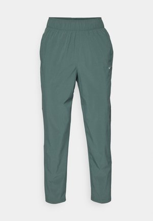 Pantaloni Nike da uomo in un colore verde smorzato, realizzati in tessuto leggero con cintura elastica e gambe affusolate. Presentano un design minimalista e il logo.