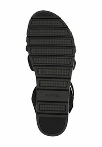 Suola di sandalino nera con grip testurizzato, caratterizzata da scanalature orizzontali e diagonali. Include logo del marchio e indicazioni della taglia.