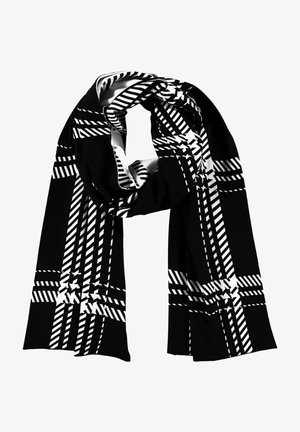 Écharpe noire avec un motif à carreaux géométrique blanc, bouclée de manière lâche.