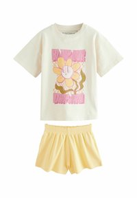 Korte mouwen crème t-shirt met een kleurrijke bloemenafbeelding, gecombineerd met gele ribgebreide shorts met een elastische tailleband.