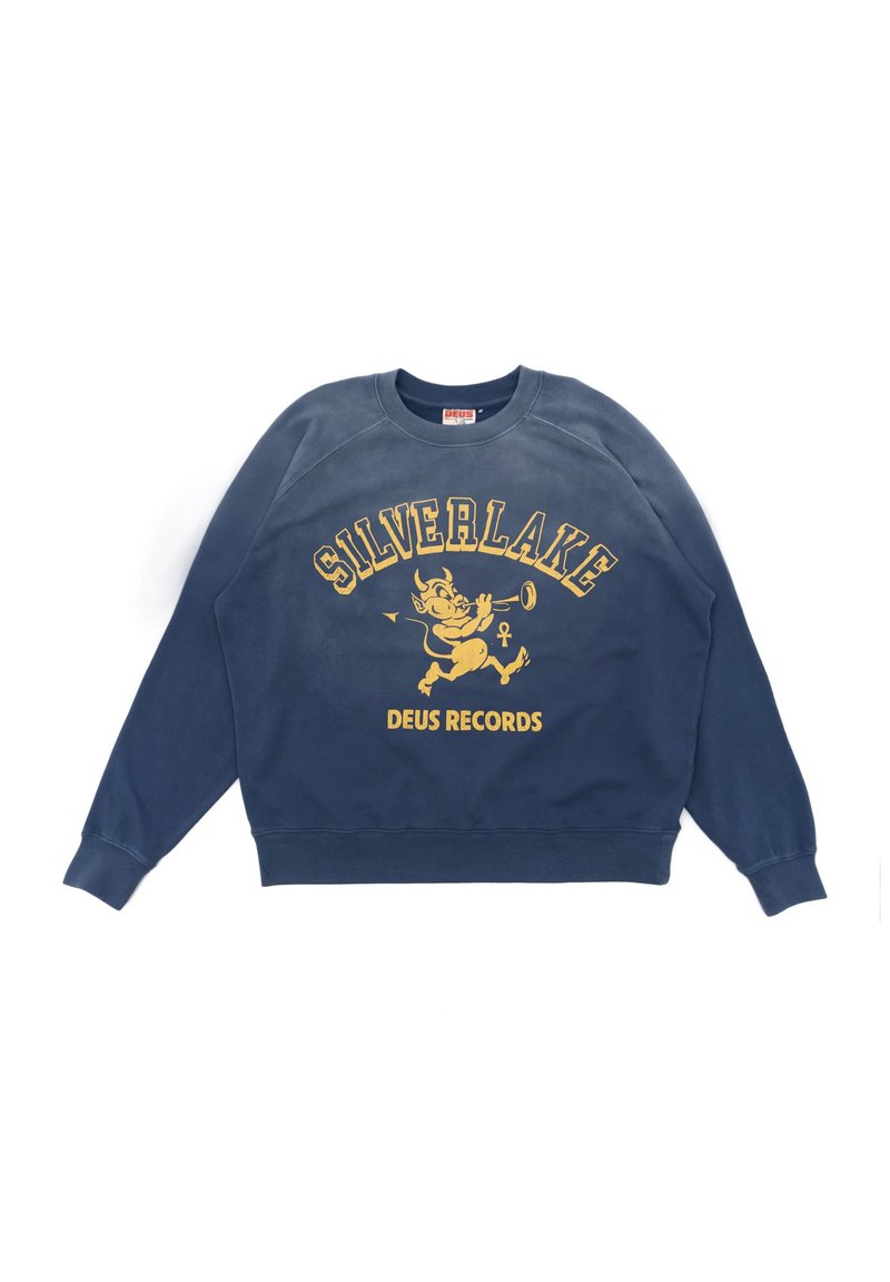 Felpa di colore blu navy con una stampa grafica gialla che presenta le scritte "SILVERLAKE" e "DEUS RECORDS", insieme a un personaggio dei cartoni animati che suona la tromba.