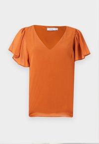 Blouse orange à manches courtes avec col en V et manches volantées froncées sur un fond gris clair uni.