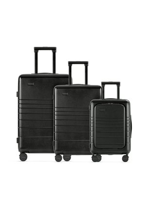 Black three-piece luggage set: hard shell, textured finish, horizontal grooves, retractable handle, 360-degree spinning wheels.