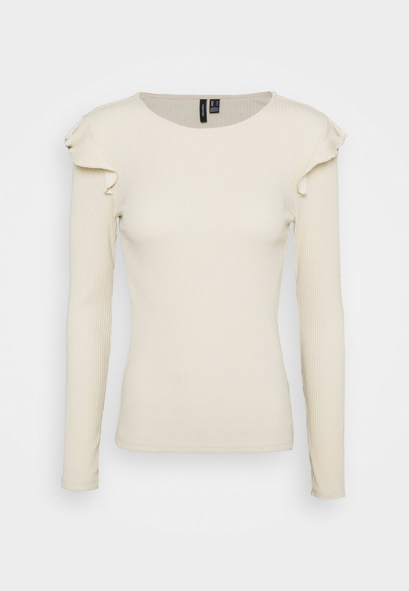 Light beige long-sleeve top with ribbed texture, round neckline, and ruffled accents on shoulders. Fitted design.