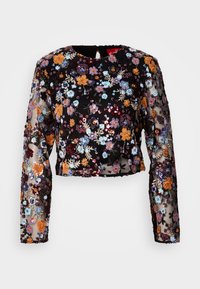 Zwarte cropped top van doorzichtig materiaal, versierd met kleurrijke bloemenborduursels en pailletten. Lange mouwen met complexe details.