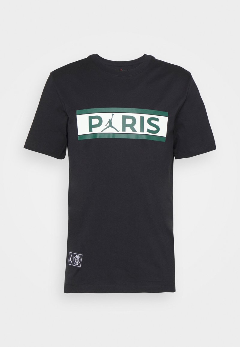 Black cotton t-shirt featuring a large white and green graphic that reads "PARIS" with a Jumpman logo above and a logo patch on the side.