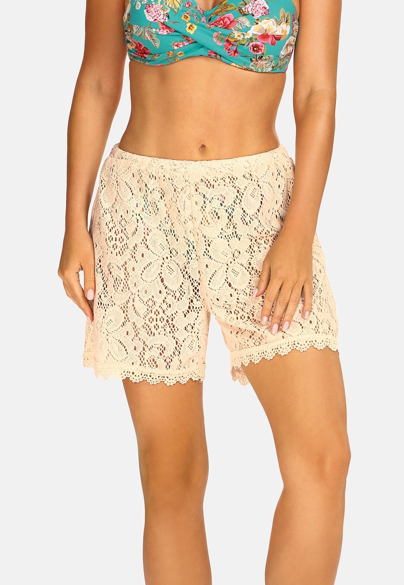 Szorty koronkowe w jasnym brzoskwiniowym kolorze z kwiatowym wzorem. Posiadają falbaniasty dół i elastyczną talię. Lekki, oddychający materiał.