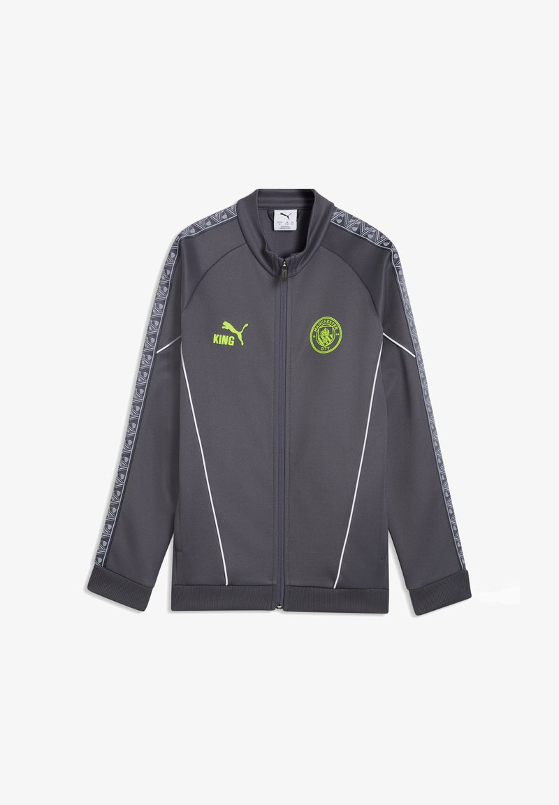 Veste zippée Puma gris foncé avec logo Manchester City et texte "KING" en jaune néon, rayures à motifs le long des manches, et détails en passepoil blanc.