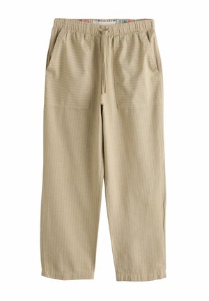 Beige Freizeithosen mit dünnen vertikalen Streifen, elastischem Bund, Kordelzug, zwei aufgesetzten Fronttaschen und elastischen Bündchen am Knöchel.