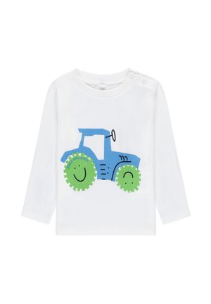 Camicia bianca a maniche lunghe con una grafica di un trattore blu e ruote sorridenti verdi, con contorni neri e dettagli con bottoni sulla spalla.