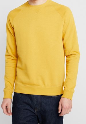 Felpa di cotone gialla con colletto rotondo e polsini a coste. Presenta maniche raglan e una texture liscia e morbida.