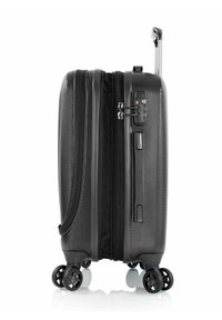 Black hard-shell suitcase with textured surface, retractable handle, zipper closure, integrated lock, and smooth spinner wheels.