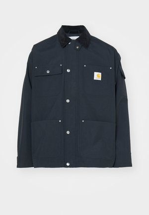 Marineblaues Jackett mit einem Cordkragen, Druckknöpfen und vier Taschen. Mit einem gelben Logopatch auf der linken Brust. Robustes Material, strukturiertes Design.