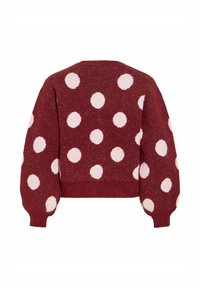 Suéter burdeos con lunares blancos, diseño corto, tejido de punto texturizado y mangas abullonadas. Bajo y puños acanalados.