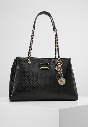 Sac à main en simili cuir noir avec un extérieur à motifs, des anses en chaîne argentée et des charms décoratifs. Il présente une plaque logo à l'avant.