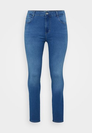 Kapeimmat farkut keskisinisestä denim-kankaasta, joissa on tavallinen nappi- ja vetoketjukiinnitys, viisi taskua sekä lievä haalistuminen lahkeissa.