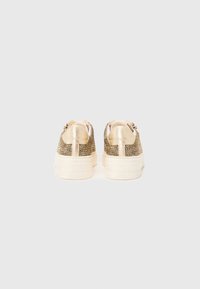 Textured gold and cream sneakers with a platform sole, featuring a mix of metallic threading and smooth accents. Back view.