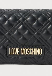 Zwarte gewatteerde leren tas met ruitvormige stiknaden en vergulde "LOVE MOSCHINO" logo plaat in het midden van de voorkant.