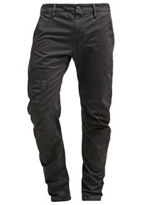 Svarta bomullstrosor med smal passform, med subtila slitna partier framtill och traditionella knappar samt bälteshällor.