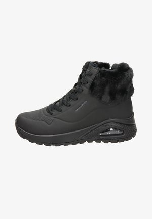Zapatilla negra de caña alta con parte superior impermeable texturizada, cuello forrado de pelo, cierre de cordones en el frente y suela acolchada con aire visible.