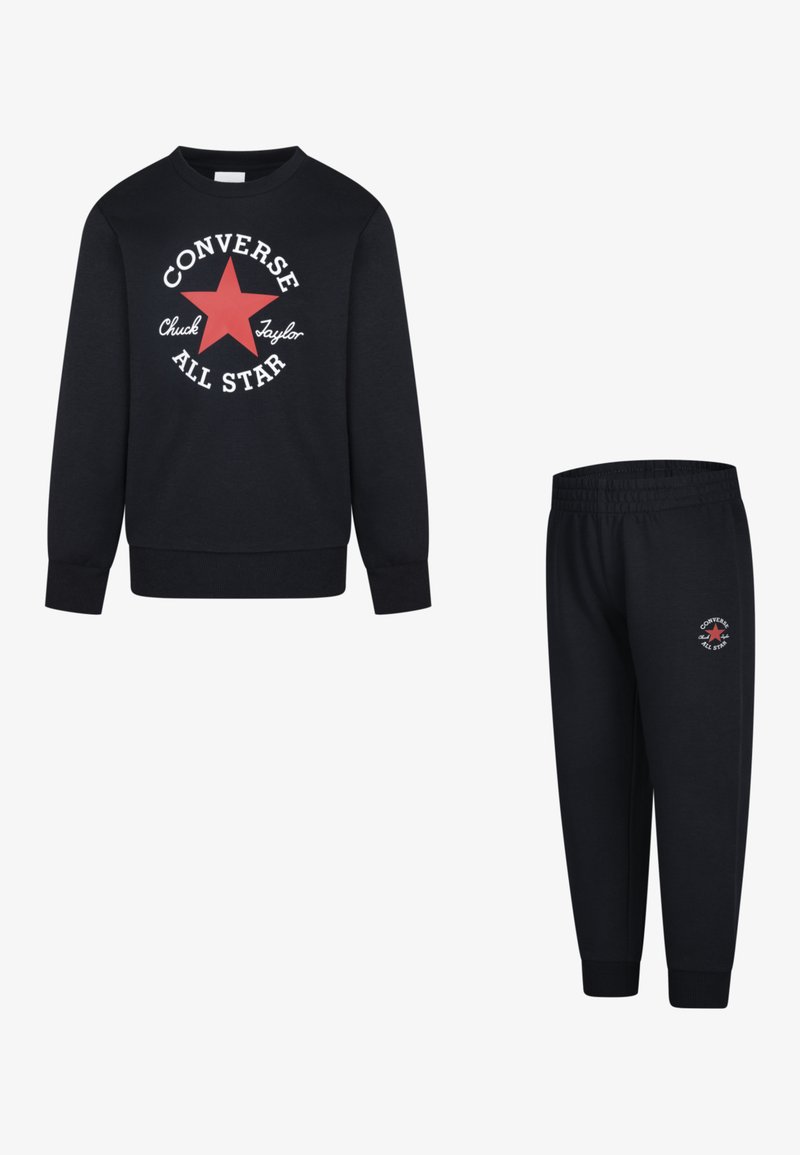 Black sweatshirt and joggers set featuring a red star logo and white text. Soft fabric, ribbed cuffs, and elastic waistband on joggers.