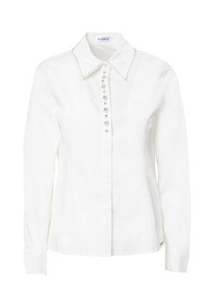 Blusa bianca in cotone con colletto a punta, placket dei bottoni decorato con gemme trasparenti e maniche lunghe con polsini abbottonati.