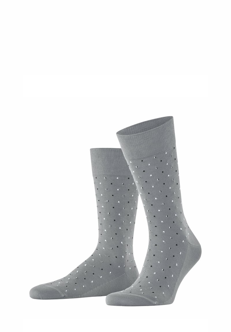 Graue Socken mit einem gerippten Muster, versehen mit einem Design aus kleinen schwarzen und weißen Punkten. Glatte Oberfläche mit einem verstärkten Zehenbereich.