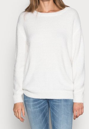 White, soft sweater with a relaxed fit, wide neckline, and long sleeves. Knit texture with ribbed cuffs and hem, paired with blue jeans.