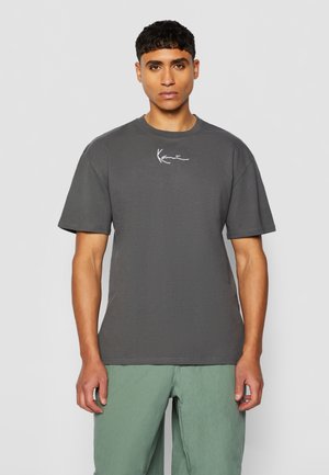 Gray short-sleeve t-shirt made of cotton, featuring a round neck and minimalistic white logo on the chest. Smooth texture and relaxed fit.