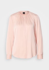 Blusa rosa chiaro con un design a pieghe, maniche lunghe, scollatura rotonda e polsini con bottoni. Realizzata in un tessuto liscio e morbido.
