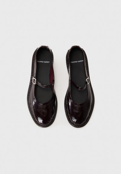 Ballerines Mary Jane en cuir verni bordeaux foncé avec un bout arrondi, une bride avec une boucle et une semelle texturée. Doublure intérieure noire.