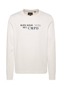 Cream-colored sweatshirt with long sleeves and round neckline. Features navy blue text: "BLEU AZUR NO/1 CMPD" with a Saint-Tropez design.