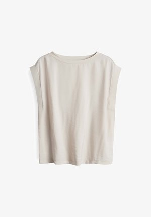 Haut à manches courtes de couleur beige clair, fabriqué en tissu doux, avec un large col et des coutures d'épaule tombantes, offrant une coupe décontractée et un design minimaliste.