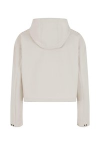 Veste à capuche courte de couleur beige clair. Elle possède des manches longues avec des accents de boutons et une texture lisse. Design minimaliste sans logos visibles.
