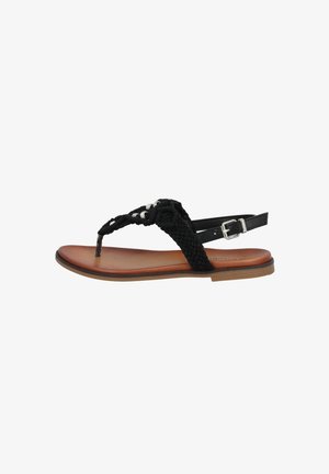 Black braided sandal with a flat brown sole, textured straps, and silver hardware accents. Adjustable ankle buckle for fit.