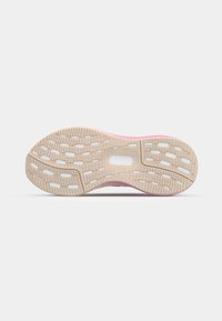 Athletic shoe sole featuring a flexible beige rubber outsole with pink accents, textured for grip, and patterned with cut-out sections.