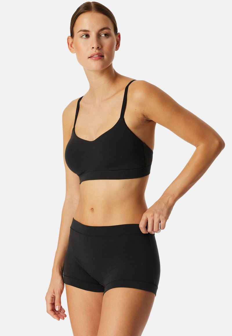 Black bralette and matching boyshorts made from smooth fabric. Bralette has thin straps and a v-neck design, while shorts feature a stretchy waistband.
