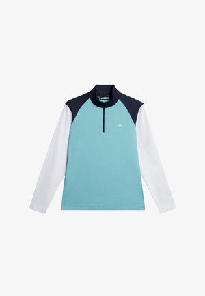 Długi rękaw sportowej koszulki w jasnoniebieskim kolorze, z granatowymi akcentami na kołnierzu i ramionach. Posiada zamek na ćwierć długości oraz logo.