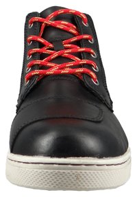 Black leather shoe with red and yellow patterned laces, a smooth finish, round toe, and a textured white rubber sole.