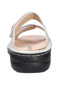 Silver leather sandals with three straps, a contoured footbed, and a black rubber sole featuring white stitching along the edge.