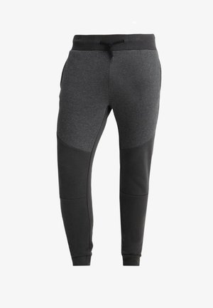 Gray sweatpants with black accents, tapered fit, elastic waistband with drawstring, side pockets, and textured fabric panels.