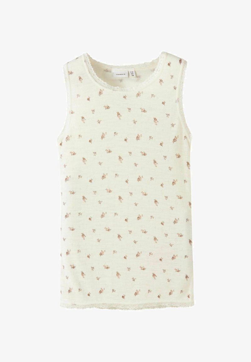 Top brez rokavov iz lahkotnega materiala, v kremni barvi z majhnimi cvetličnimi vzorci v rjavi in rožnati barvi. Čipkast rob okoli izreza.