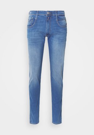 Blue denim jeans with a slim fit. Features five pockets, a front button closure, and light fading on the legs. Straight leg cut.