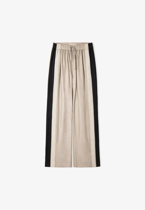 Pantalones beige de pierna ancha con franjas verticales negras y crema en los costados, cinturilla elástica y cordón delantero sobre fondo blanco.