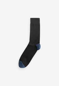 Sort sok med ribbet manchet og mørkeblå hæl og tå. Lavet af glat materiale med ensfarvet design.