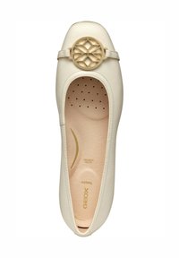 Zapato plano de cuero blanco con puntera redonda, que presenta una hebilla geométrica dorada decorativa y una plantilla acolchada beige con perforaciones.