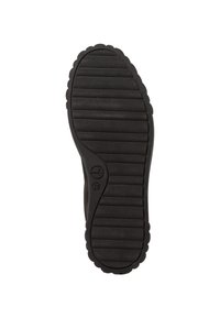 Semelle de chaussure en caoutchouc noir avec des rainures horizontales et un bord festonné. Présente un logo circulaire près de la voûte plantaire et une surface texturée pour l'adhérence.