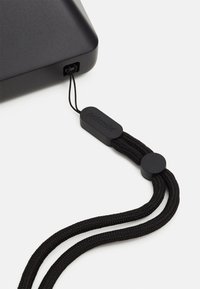 Black rectangular case with a smooth matte finish, featuring a black braided strap attached by a loop and plastic accent labeled "polaroid."