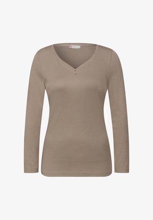 Lichtbruine top met lange mouwen gemaakt van zachte stof. Heeft een V-hals met twee knopen, een slanke pasvorm en eenvoudige stiksel details.